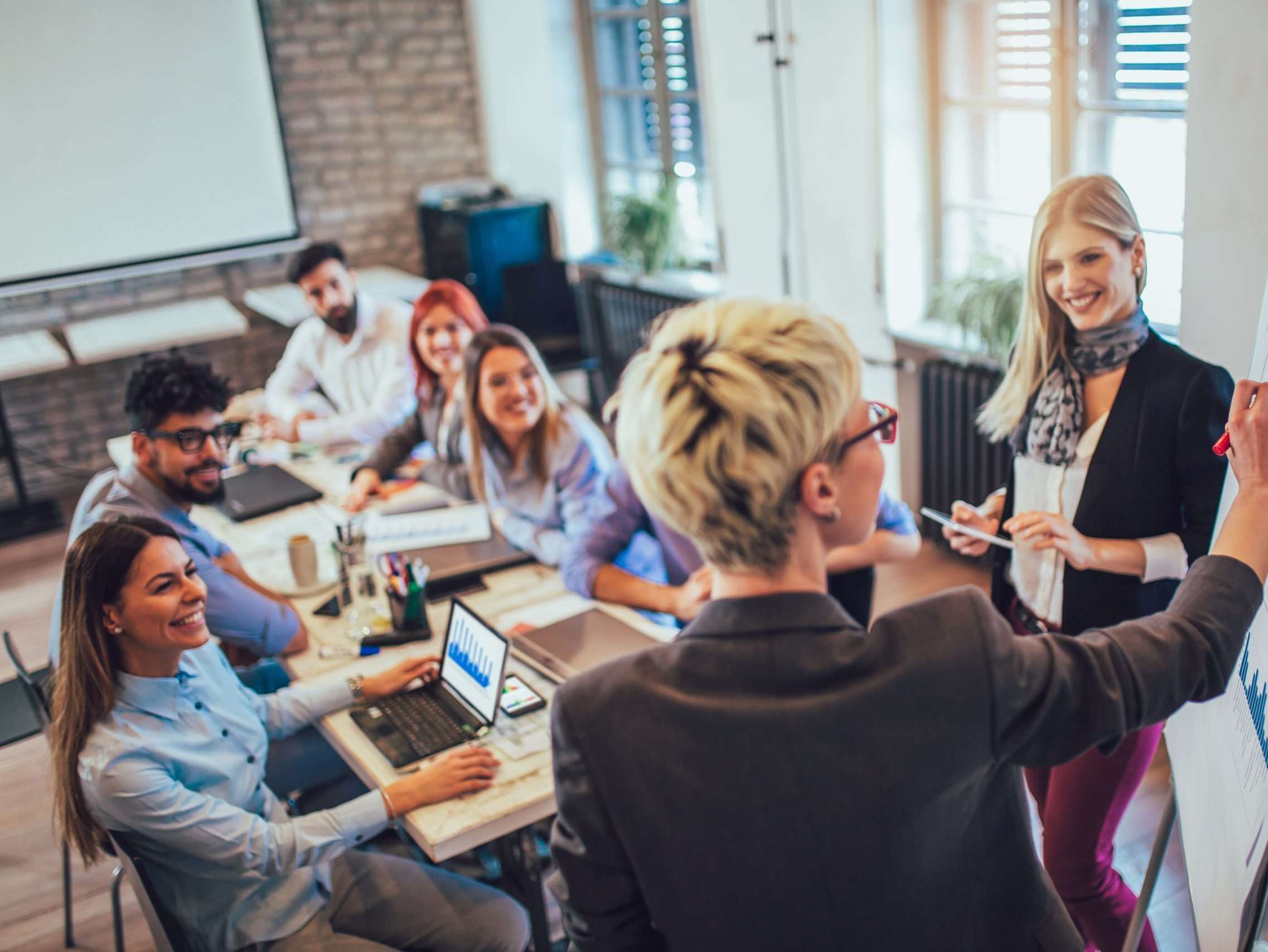 Business colleagues in conference meeting room during presentati