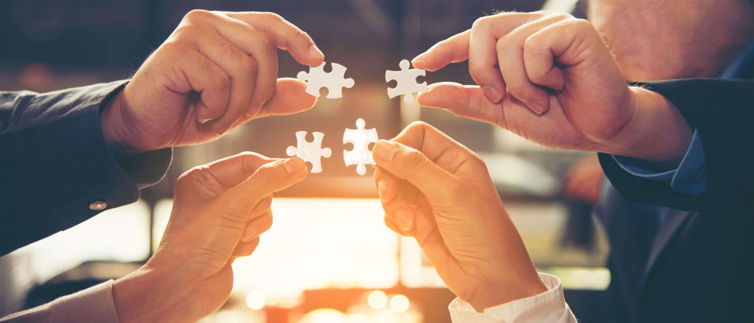 Group of Business people hands are holding and conecting jigsaw