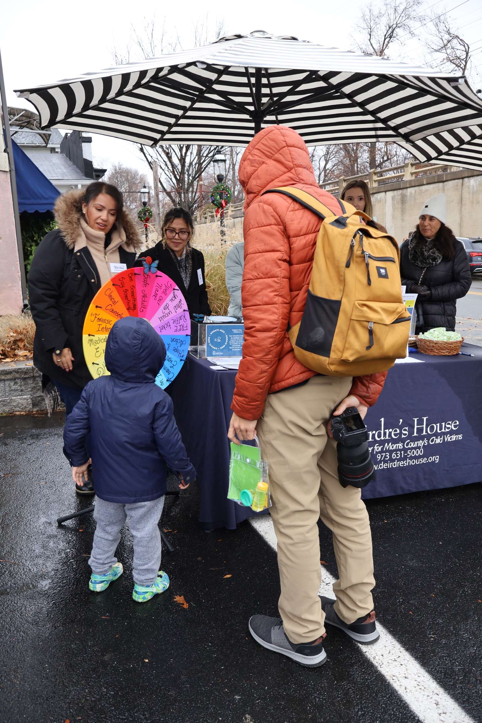 Families participating in an outdoor community event with educational activities.