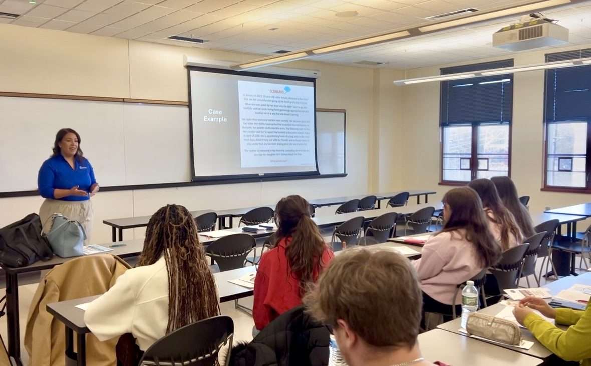 Attendees watching a presentation in a conference room.