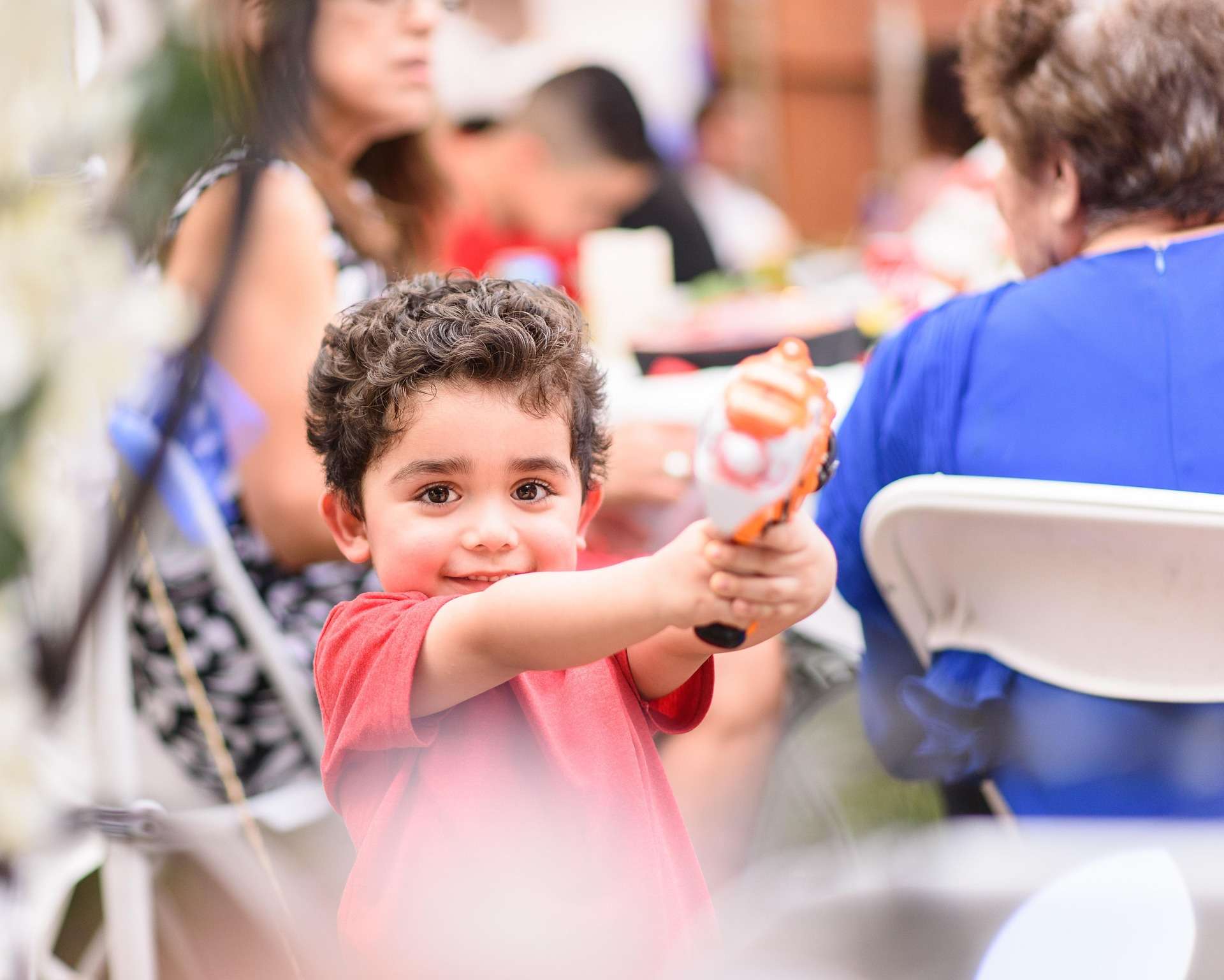 Young child enjoying an activity at a table.
